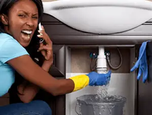 Emergency plumbing repair for a leaking sink drain under a bathroom vanity in Denver, CO