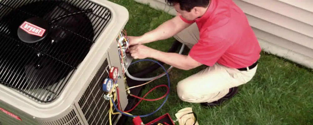 HVAC technician servicing an outdoor air conditioner unit in Denver, CO