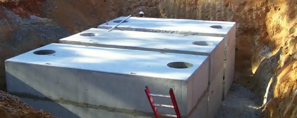 Septic tank installation site with a newly placed concrete tank in Denver, CO